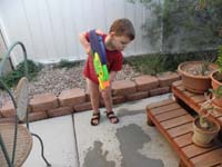 32-Kenny_likes_to_shoot_Daddy's_footprints_with_the_water_gun