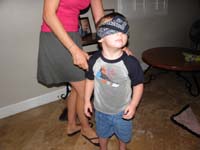09-Kenny's_blindfolded_to_play_'pin_the_lightsaber_on_Luke_Skywalker'