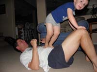 45-Kenny_really_likes_jumping_on_Daddy's_stomach-it_starts_to_hurt_after_a_few-but_Kenny_has_fun