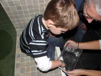 034-Kenny_reaches_into_a_small_tank_to_touch_a_crab