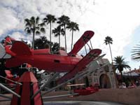 083-Kenny_riding_a_bi-plane_with_a_friend_he_made_in_line