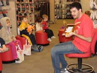 08-story_time-cute_Kenny_listening_with_his_stuffed_animals