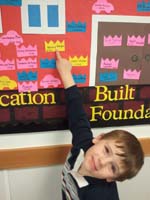 12-Kenny_shows_his_alphabet_crown_on_the_board_at_school