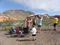 01-Kenny_supervising_putting_up_the_tent_for_shade