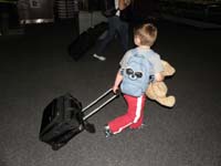 38-helper_Kenny_on_his_way_to_Daddy's_car-carts_luggage_like_a_big_person
