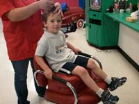 05-Kenny's_a_big_boy_now_getting_his_haircut_in_a_chair_with_a_booster_seat