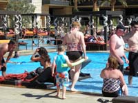 57-Mommy_and_Kenny_approaching_very_busy_M_Resorts_pool