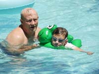 21-Grandpa_Duke_and_Kenny_with_froggy_float_in_lazy_river-Kenny_was_there_Mon-Thu