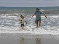07-Kenny_and_Daddy_running_from_a_wave-Daddy_decides_he_now_wants_his_bathing_suit