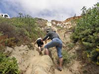 31-wet_dirty_Kenny_scrambles_up_the_cliff