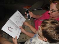 17-Kenny_reading_a_BOB_book_to_Baba_on_the_phone