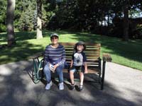 38-Baba_and_Kenny_sitting_on_a_bench_ready_to_go_on_the_boat_for_a_ride_around_the_lake