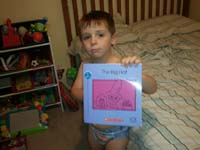 16-Kenny_shows_off_the_Bob_book_he_read_to_Daddy-The_Big_Hat
