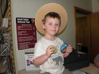 151-Kenny_shows_his_badge_and_patch