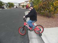28-Kenny_really_liked_riding_his_bicycle_over_the_curb