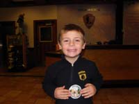55-Kenny_shows_off_his_Junior_Ranger_badge_and_patch_in_the_visitor_center