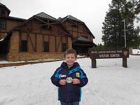 56-Kenny_shows_off_his_Junior_Ranger_badge_and_patch_outside_the_visitor_center
