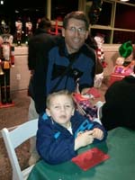 34-Kenny_and_Daddy_enjoy_a_Christmas_cookie-we_got_to_put_our_own_decorations_on_the_cookie