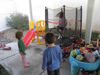 61-Kenny_and_Zoe_watching_Beeja_bounce_on_the_trampoline