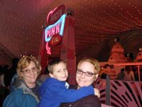 04-Grammy_Kenny_and_Mommy_in_line_for_the_Pink_Pig_ride