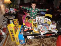 48-Kenny_shows_off_his_Christmas_loot-now_to_fit_it_all_in_suitcases_and_mailed