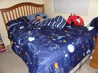 01-after_long_flight_from_Atlanta_late_at_night,Kenny_gets_to_sleep_in_his_new_bed_covering