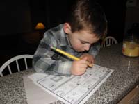 07-Kenny_doing_some_sample_kindergartner_homework-he's_intensely_thinking