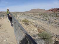 14-Kenny_and_one_of_several_petrified_logs-big_hill_out_of_sight_to_right_is_covered_with_petrified_logs