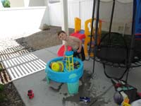 41-Kenny_playing_with_his_water_table_in_backyard
