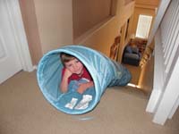 73-Kenny_in_tube_at_top_of_stairs_waiting_for_Mommy_to_pull_him_down