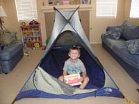 02-Kenny_earns_'Les_is_Last'_book-he'll_read_a_camping_story_in_a_tent