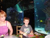 26-Mommy_and_Kenny_in_front_of_fish_tank_at_Rainforest_Cafe
