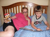 38-Kenny_reads_Scrub_and_Spray_to_Mommy_while_Baby_Giraffe_and_Fairbanks_watch