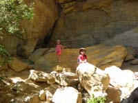15-Leyna_and_Kenny_climbing_rocks_at_Lost_Creek_Fall