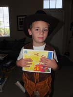 18-Kenny_dressed_as_a_cowboy_for_Circus_Day_for_last_day_of_pre-K-shows_off_'Spike_on_Stage'_kindergarten_book