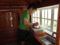 28-Kenny_playing_in_his_house_outside-he_has_lots_of_play_food_and_dishes