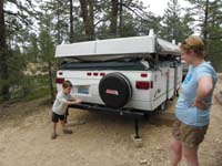 08-Kenny_helping_by_cranking_up_the_camper-haven't_used_it_for_over_a_year