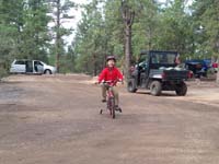 47-Kenny_is_having_lots_of_fun_riding_his_bike_around_the_campground