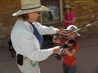 60-Kenny_gets_to_play_a_violin_at_Pipe_Spring_NM