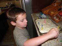 03-Kenny_puts_candles_on_the_cake_for_Mommy's_birthday_at_Baba_and_Poppy's_house