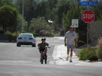 07-Kenny_shows_Poppy_how_he_can_ride_a_bike_without_training_wheels