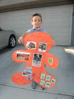66-showing_off_his_ginger_bread_man_display_for_his_school_project_for_the_week
