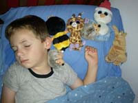 32-Mommy_found_Kenny_sleeping_like_this-he_put_all_his_buddies_in_a_row