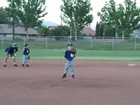 04-Kenny_playing_pitcher_position-Asst_Coach_Daddy_providing_instructions_to_another_player