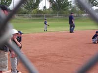 08-game_2-Kenny_in_left_field-Coach_Chris_giving_direction