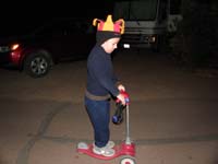 25-now_to_ride_the_scooter_in_the_street_holding_a_headlamp_like_a_headlight