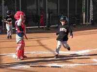 24-playing_catcher,ready_to_catch_to_get_runner_out,although_standing_behind_plate,not_in_front