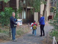 39-Poppy_greats_us_and_helps_carry_things_back_to_hotel_room-Kenny_is_trooper_and_helps_after_two_hour_nap