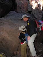 29-time_to_go_back_home-Daddy_giving_Kenny_instructions_on_using_the_rope_to_climb_up_rock