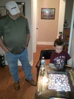21-Grandpa_Duke_watches_Kenny_play_video_games-Pac-Man